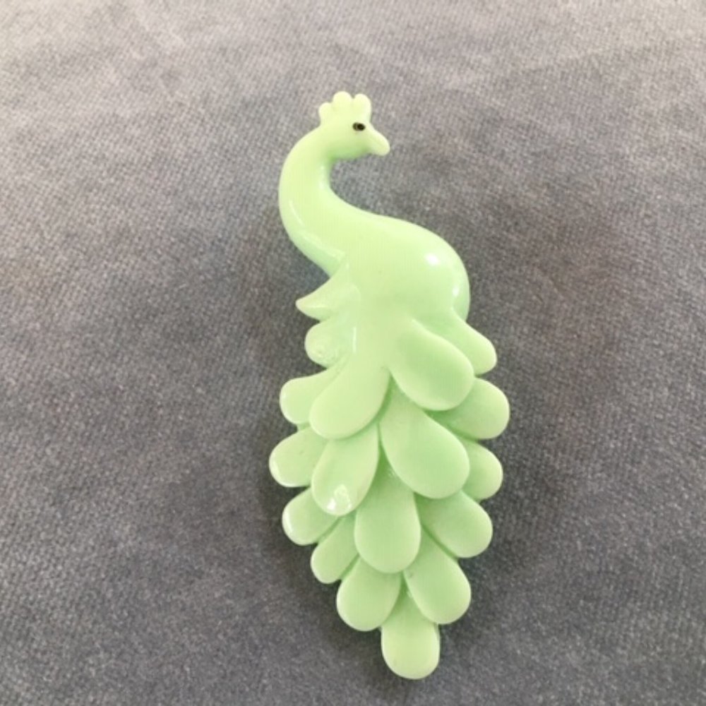 Green plastic peacock pin